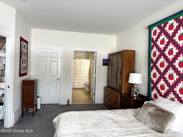 carpeted bedroom featuring ensuite bath