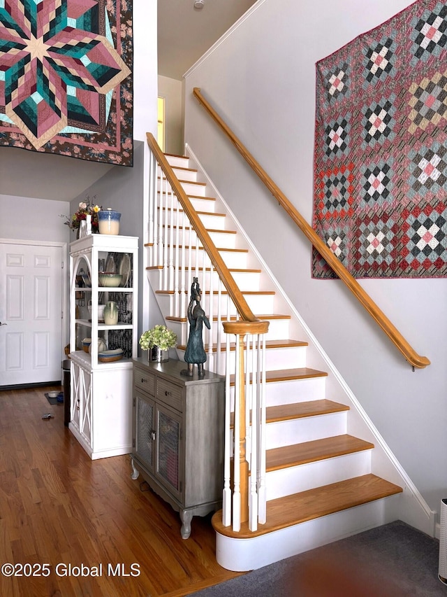 stairs featuring hardwood / wood-style flooring