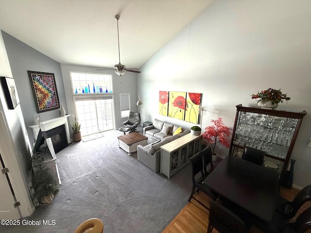 living room with ceiling fan and high vaulted ceiling