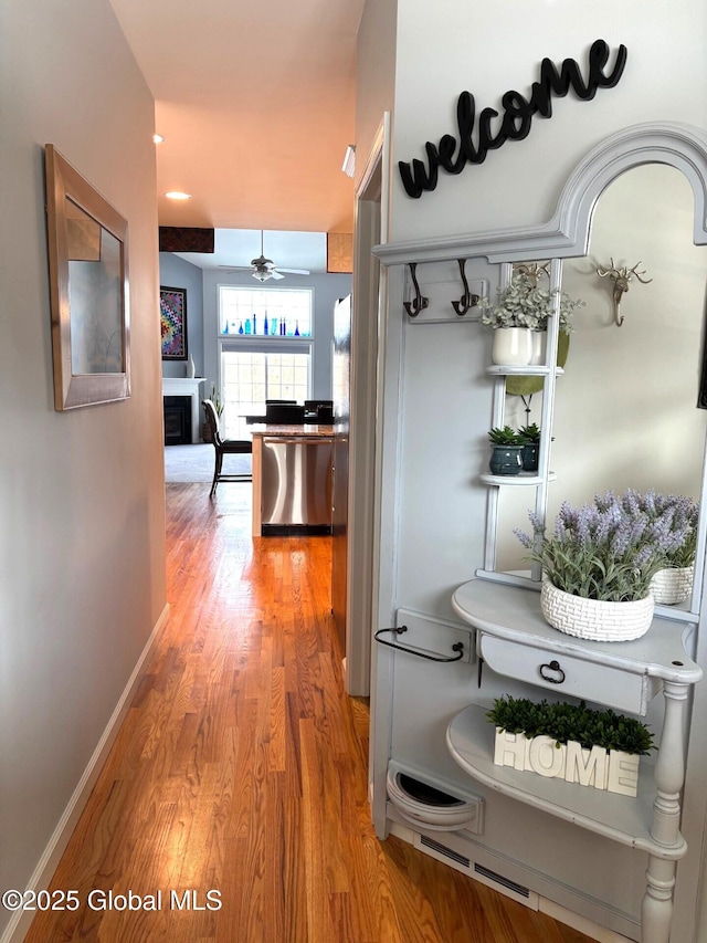 corridor with hardwood / wood-style flooring