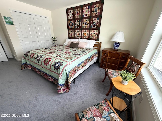 bedroom with a closet and dark colored carpet