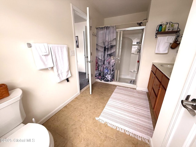 bathroom featuring walk in shower, vanity, toilet, and tile patterned flooring