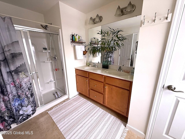 bathroom featuring tile patterned flooring, walk in shower, and vanity