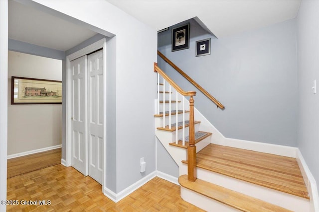 staircase featuring baseboards