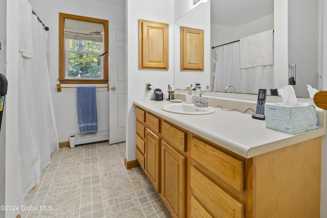 bathroom with vanity and a baseboard heating unit