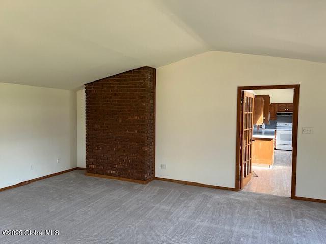 bonus room featuring baseboards, vaulted ceiling, and light carpet