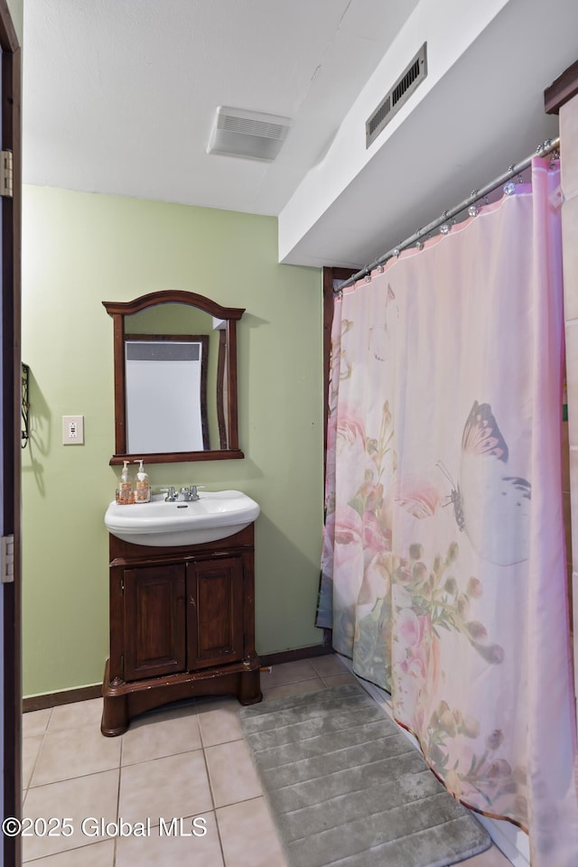 bathroom featuring vanity, curtained shower, and tile patterned floors