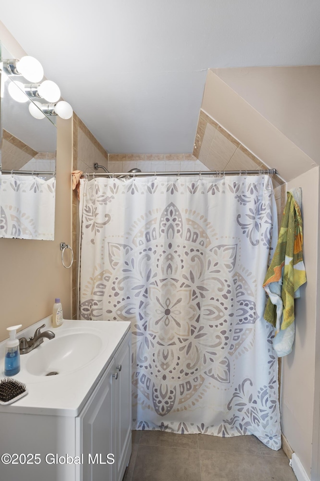 bathroom featuring walk in shower, vanity, and tile patterned flooring