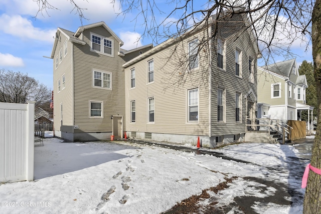 view of snow covered rear of property