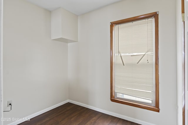 empty room with dark hardwood / wood-style flooring