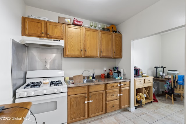 kitchen with sink, gas range gas stove, and light tile patterned flooring