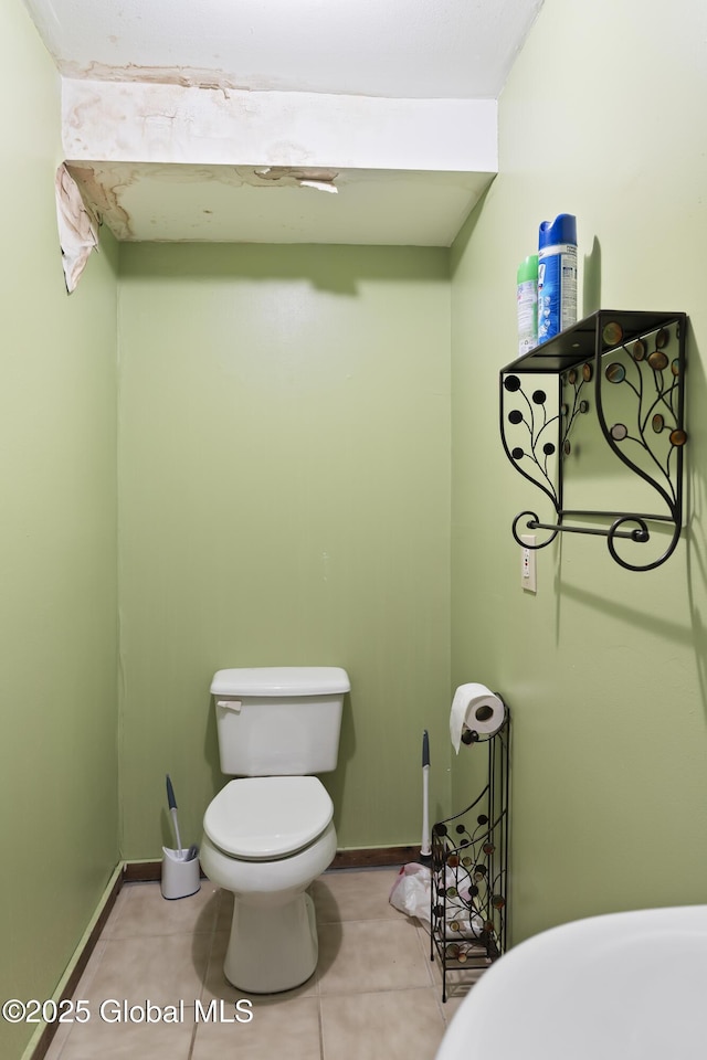 bathroom with toilet and tile patterned flooring