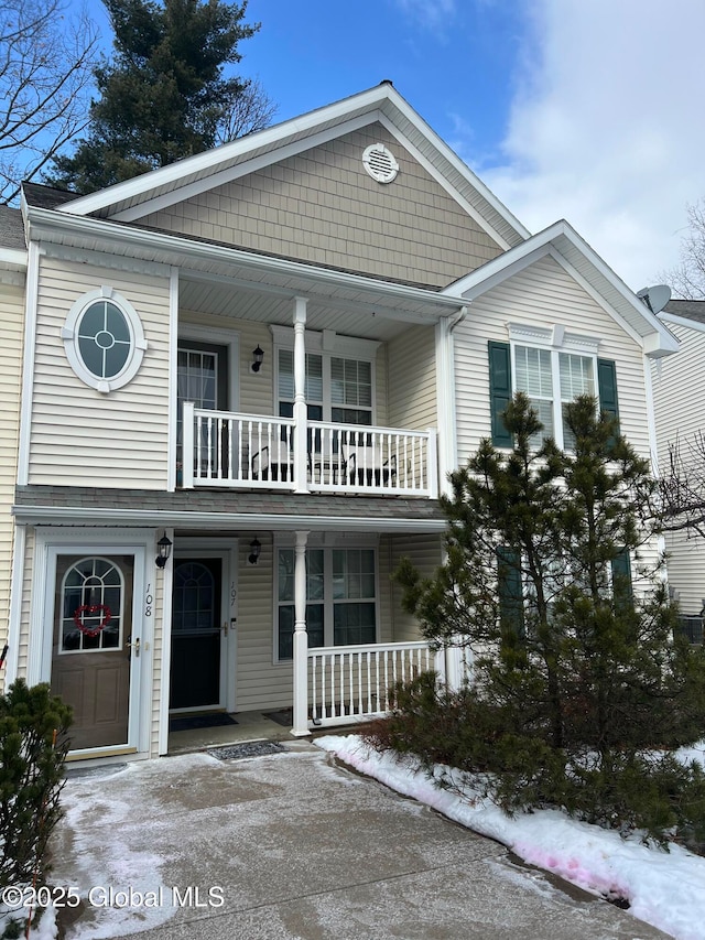 view of front of property with a balcony and covered porch