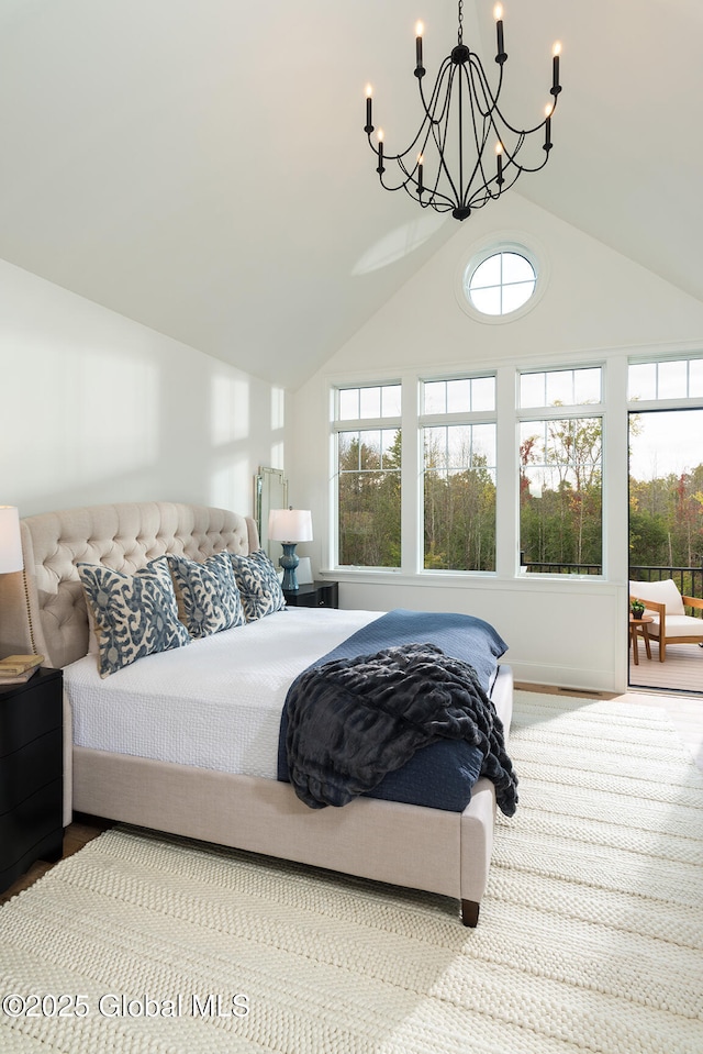 bedroom featuring lofted ceiling and a notable chandelier