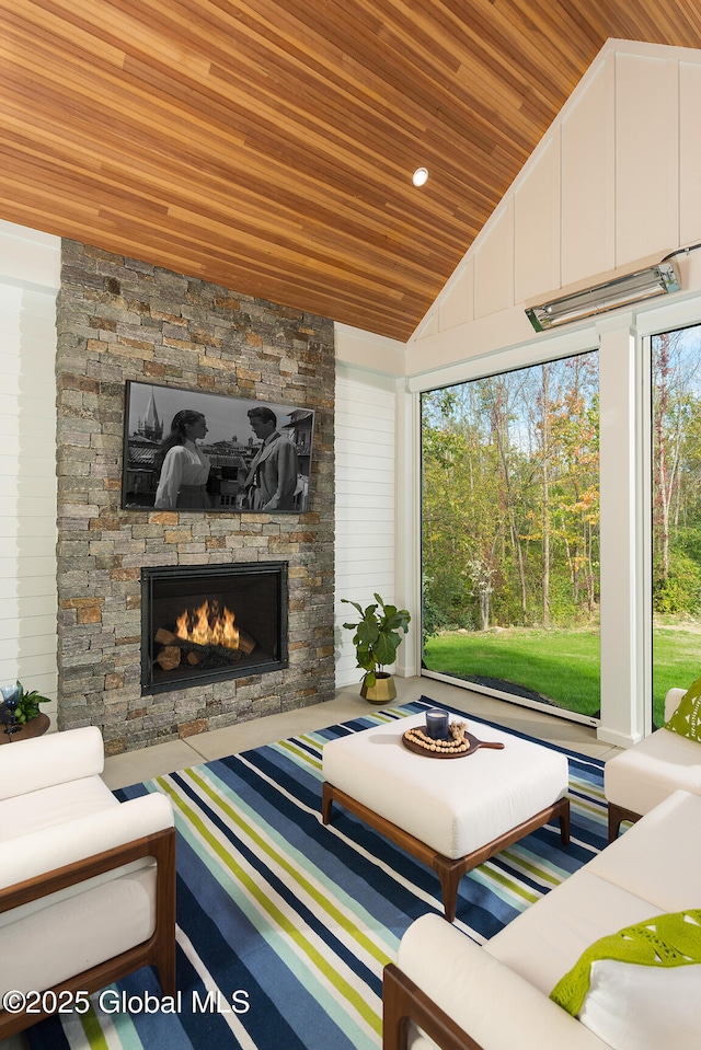 living room featuring vaulted ceiling, wooden ceiling, and a fireplace