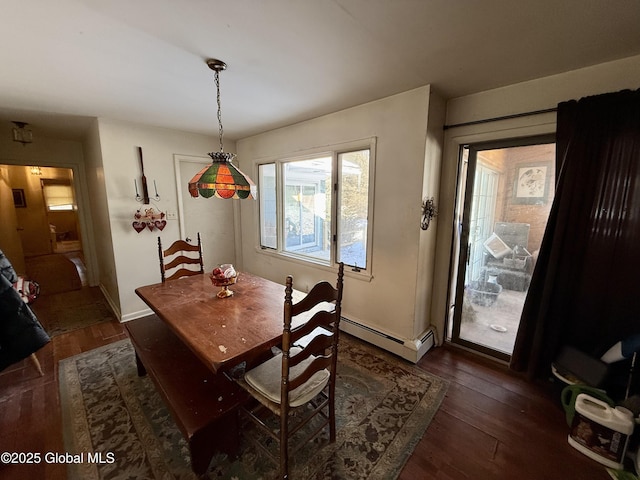 dining space with a baseboard radiator and dark wood-type flooring