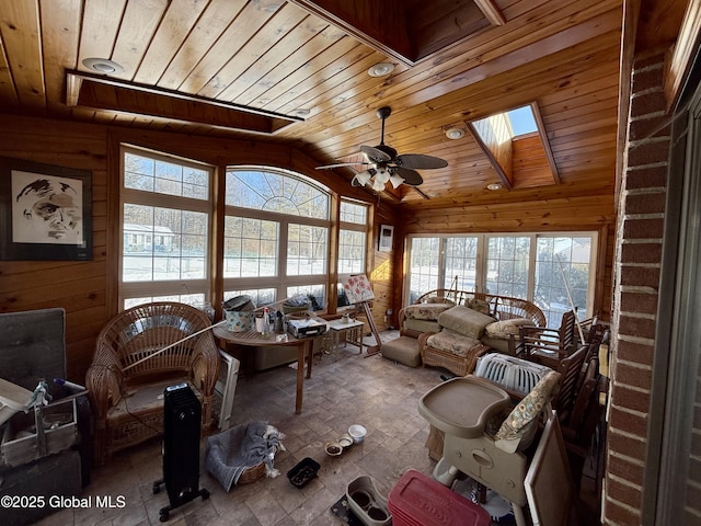 sunroom / solarium with ceiling fan, wooden ceiling, and lofted ceiling with skylight