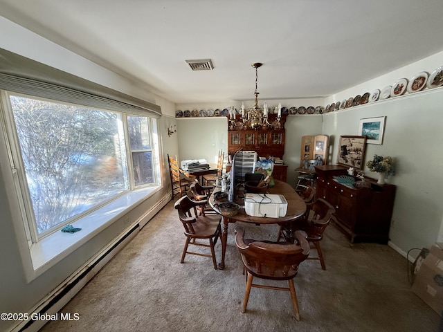 carpeted dining space featuring baseboard heating and a chandelier