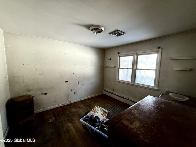 interior space featuring dark hardwood / wood-style floors and a baseboard heating unit