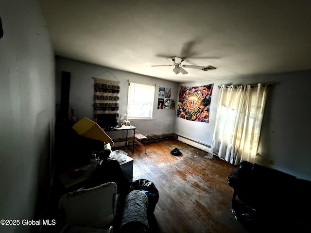 miscellaneous room featuring ceiling fan, a baseboard radiator, and wood-type flooring