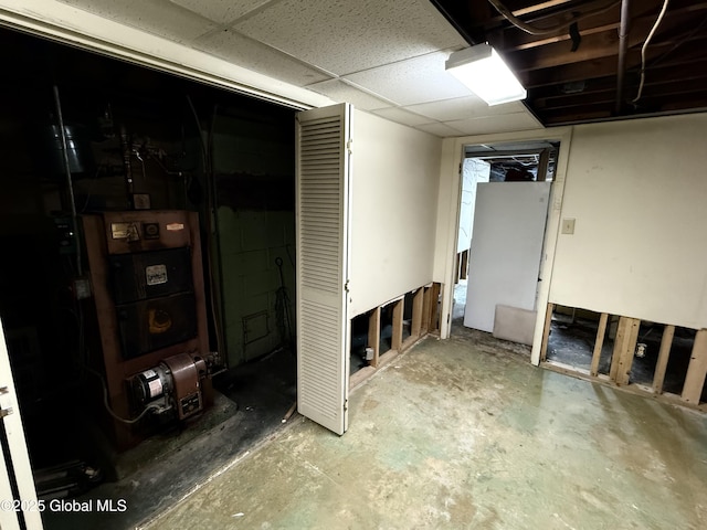 basement with a paneled ceiling