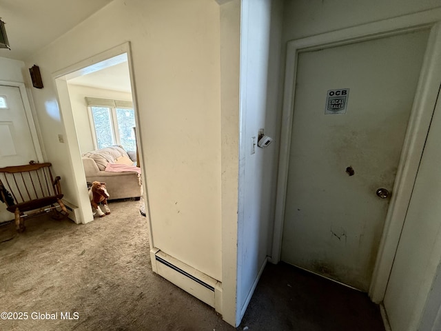 corridor with baseboard heating and carpet flooring