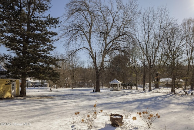 snowy yard with a gazebo