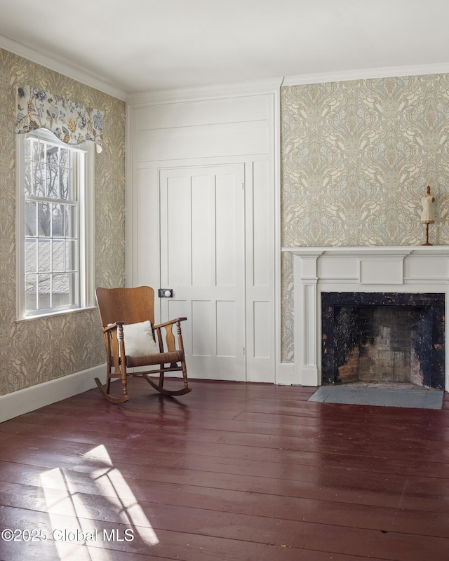 sitting room with crown molding and dark wood-type flooring