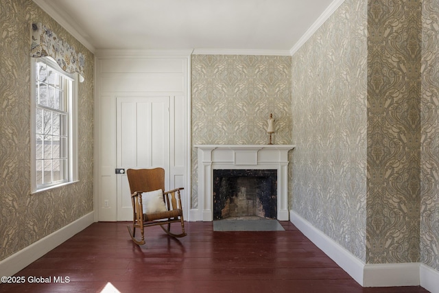 sitting room featuring dark wood-type flooring, a fireplace, and crown molding