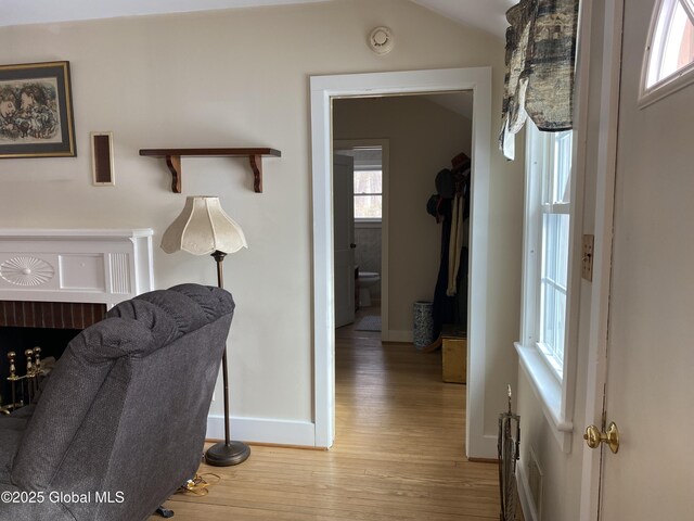 hall featuring vaulted ceiling and hardwood / wood-style floors