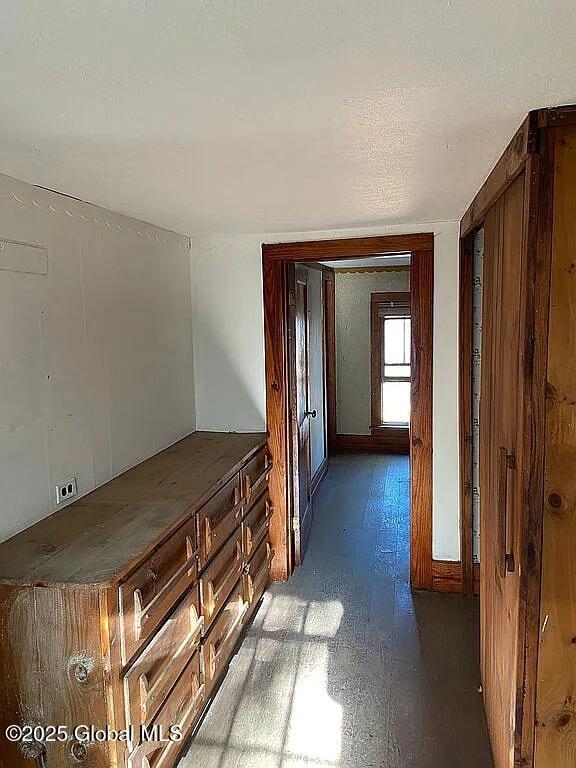 hall featuring a textured ceiling