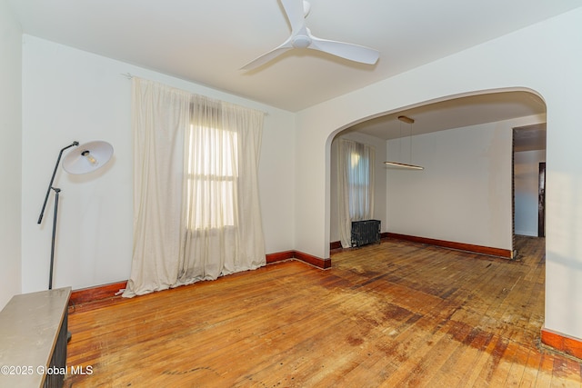 unfurnished room with hardwood / wood-style flooring and ceiling fan