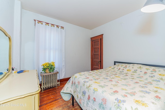 bedroom featuring dark hardwood / wood-style floors and radiator heating unit