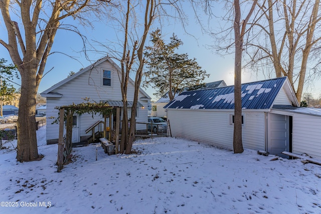 view of snow covered back of property