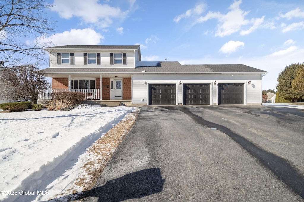 front of property with a porch and a garage