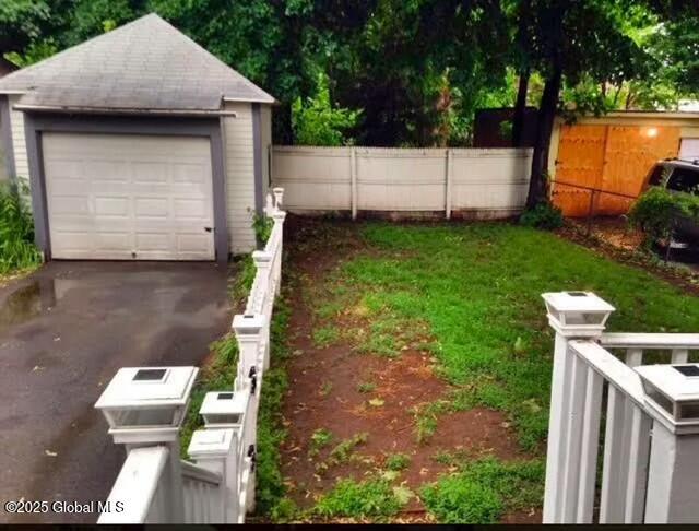 view of yard with an outbuilding and a garage