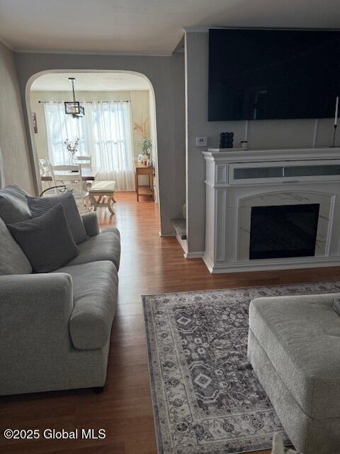 living room featuring a tiled fireplace and hardwood / wood-style floors