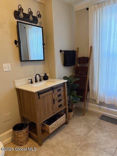 bathroom with ornamental molding, vanity, toilet, and tile patterned floors