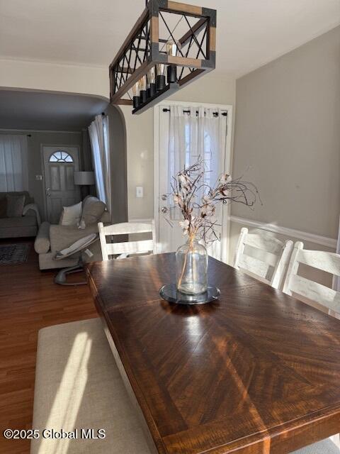 dining space with wood-type flooring