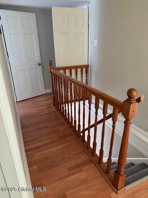 stairway featuring wood-type flooring