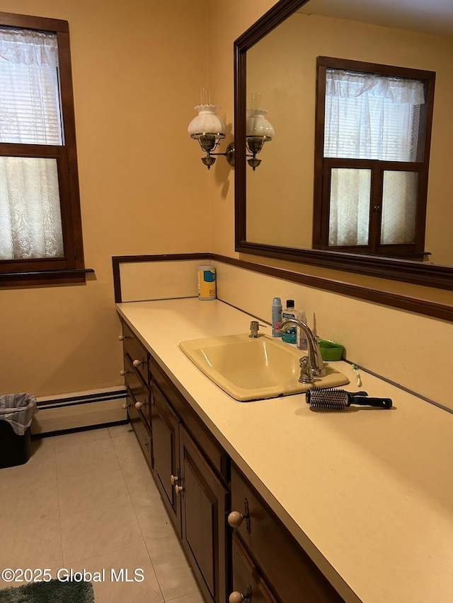 bathroom featuring baseboard heating, vanity, tile patterned flooring, and plenty of natural light