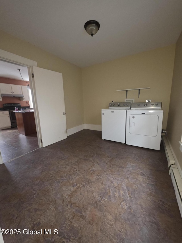 laundry room featuring a baseboard heating unit and washer and clothes dryer