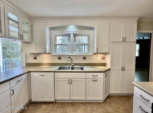 kitchen with white cabinetry, white dishwasher, backsplash, and a sink