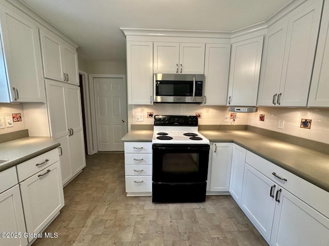 kitchen with stainless steel microwave, backsplash, range with electric stovetop, and white cabinets