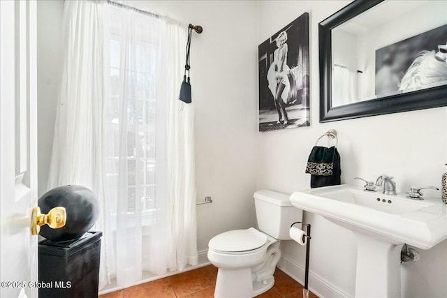 bathroom with tile patterned flooring, sink, and toilet