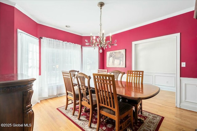 dining room with crown molding and light hardwood / wood-style floors