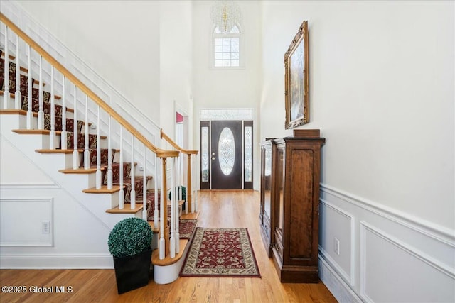 entryway with plenty of natural light, a chandelier, and light hardwood / wood-style floors