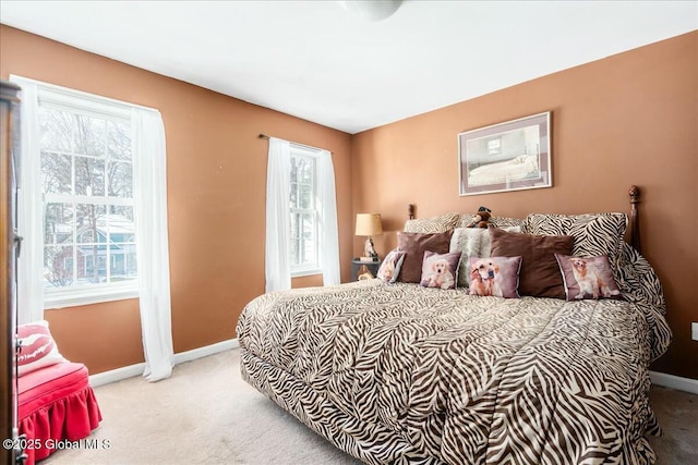 carpeted bedroom with multiple windows