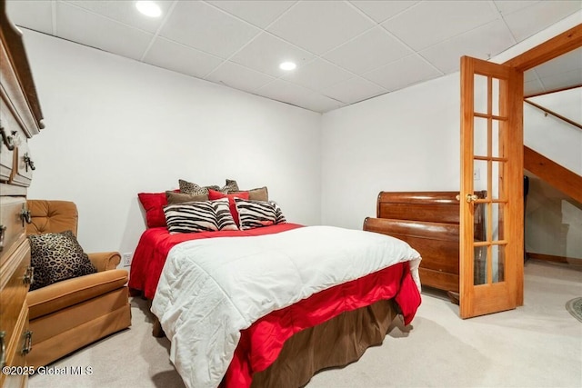 carpeted bedroom with a drop ceiling