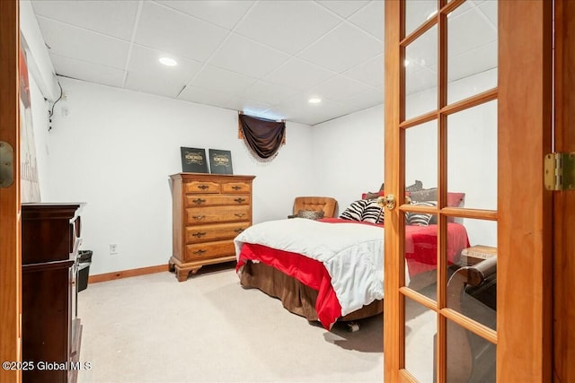 bedroom with carpet floors and a paneled ceiling